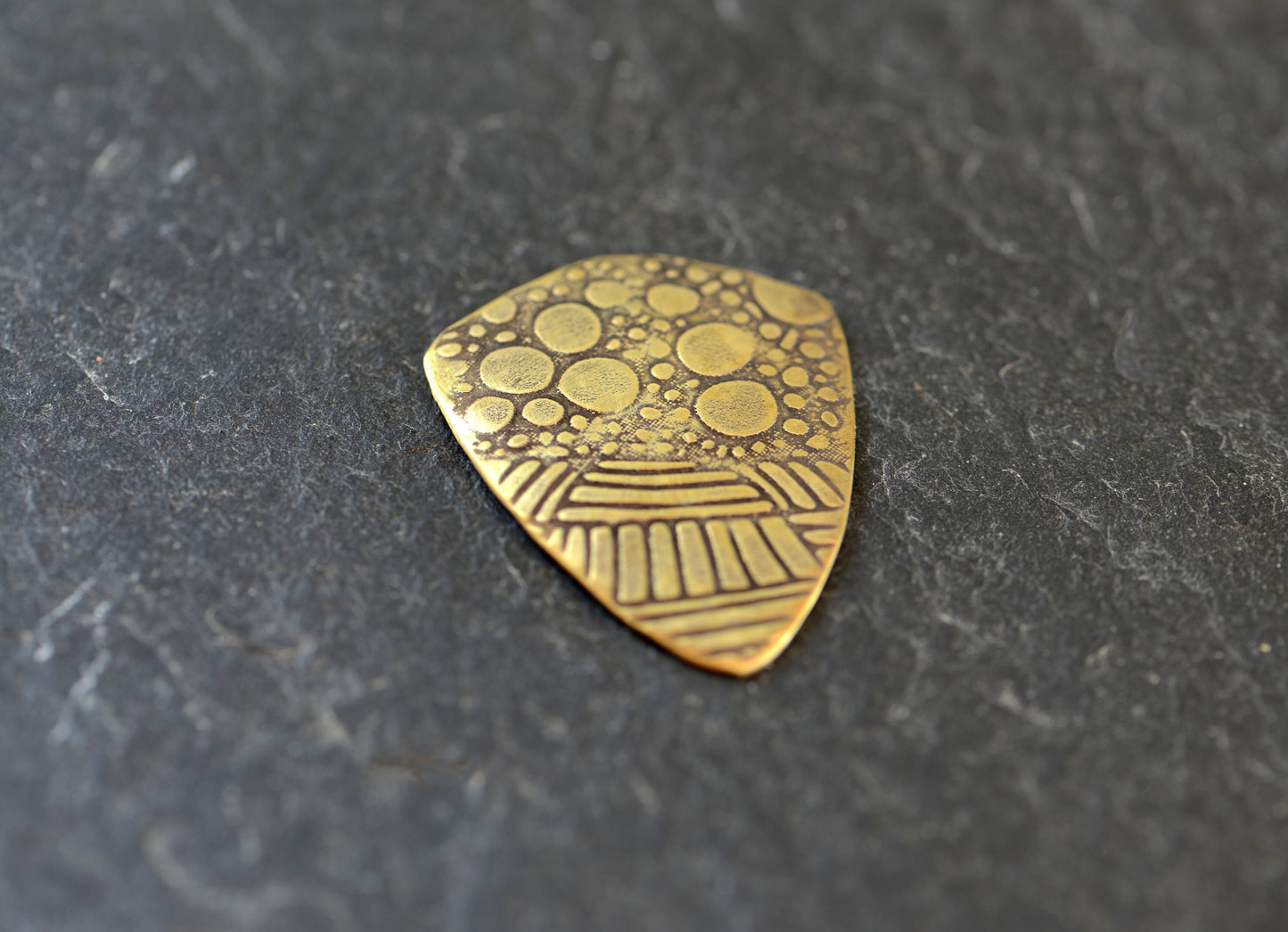 brass shield guitar pick - playable with crazy pattern
