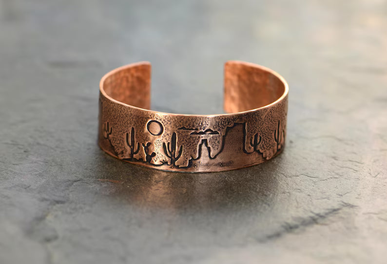Copper cuff bracelet with a desert scene landscape and cacti