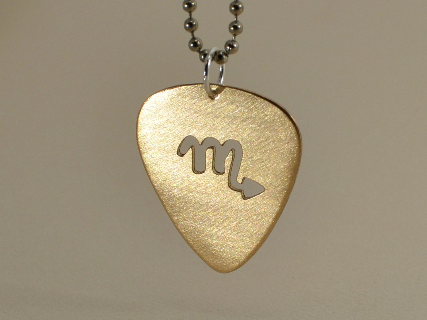 Zodiac guitar pick necklace series with cutout designs