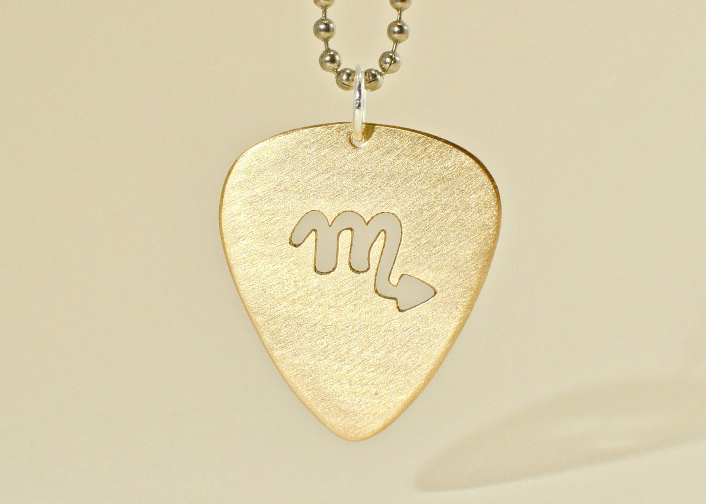 Zodiac guitar pick necklace series with cutout designs