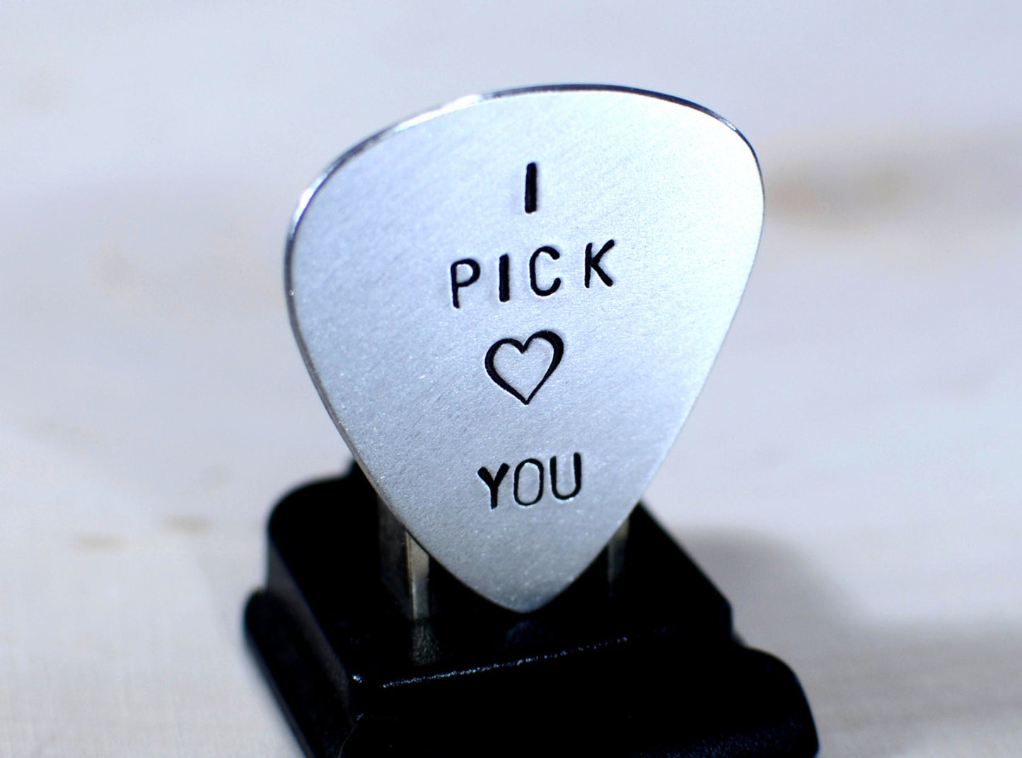 Aluminum I pick you guitar pick with a small heart design