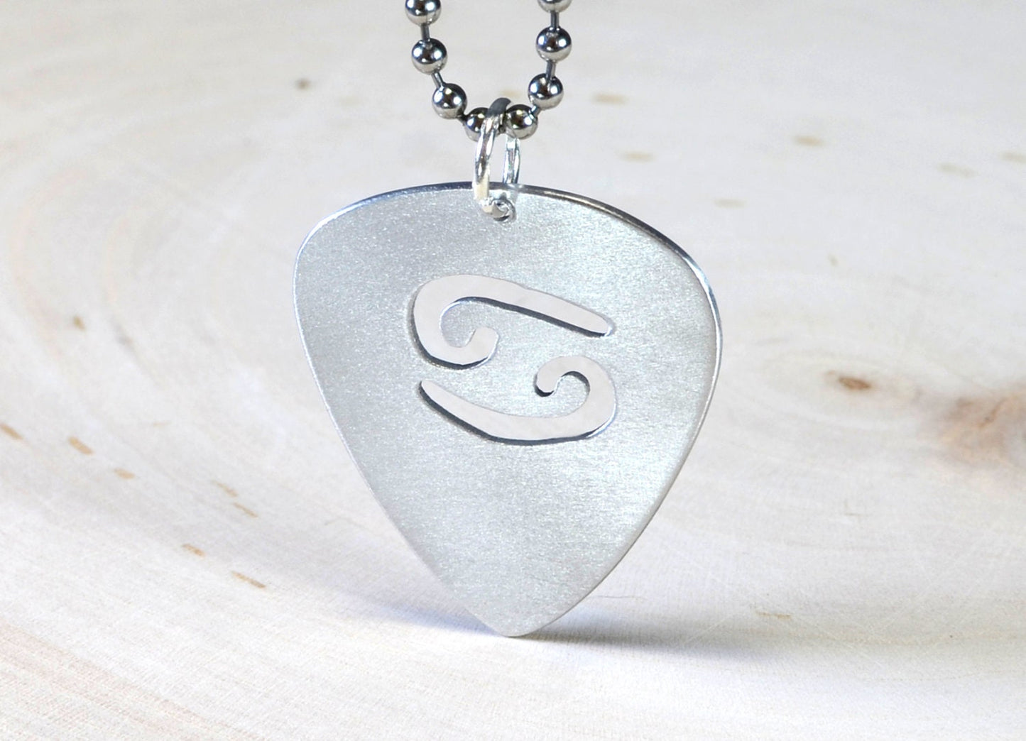 Zodiac sign guitar pick necklace with personalized astrology theme in various metals