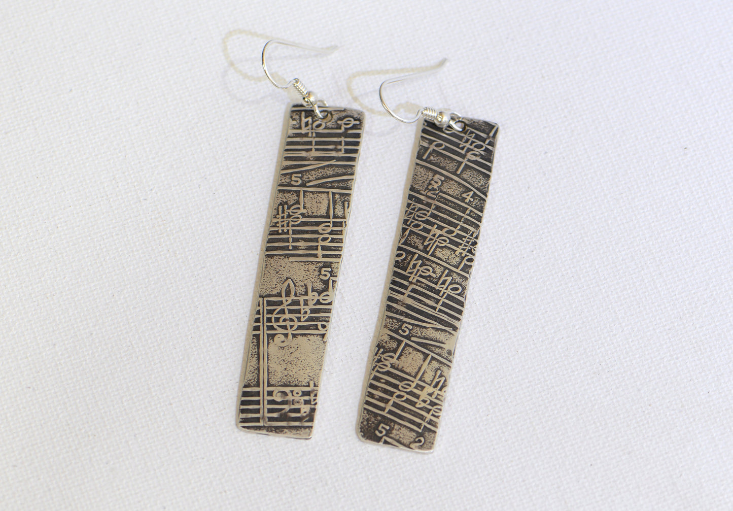 Musical Sterling Silver Earrings with Melodic Inspiration scrolled out on Antiqued Sheet Music Design