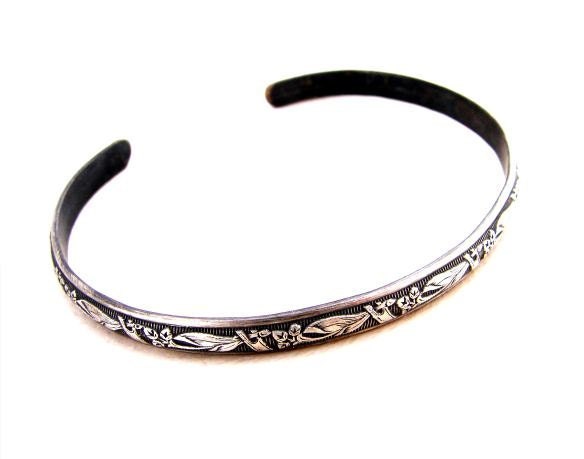 Sterling silver bracelet with floral design and patina