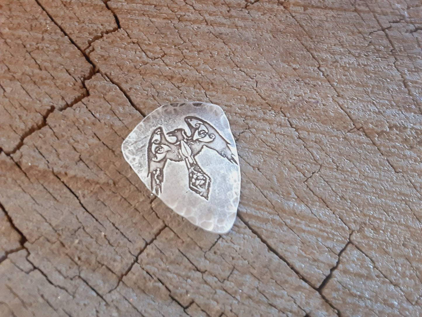 Aluminum shield shaped guitar pick playable with norse crow symbol