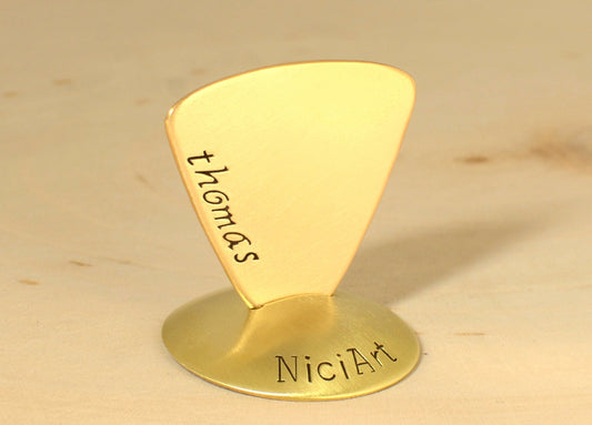 Brass triangular guitar pick with custom names and engraving