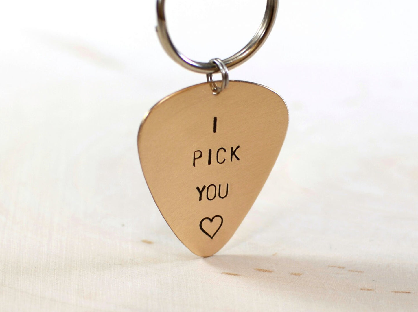 Bronze guitar pick keychain stamped with I PICK YOU