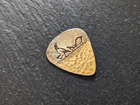 Bronze guitar pick with desert quail and a sparkly hammered texture - playable guitar pick