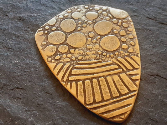 Brass shield guitar pick - playable with wild pattern - backside hammered - NicisPicks Original