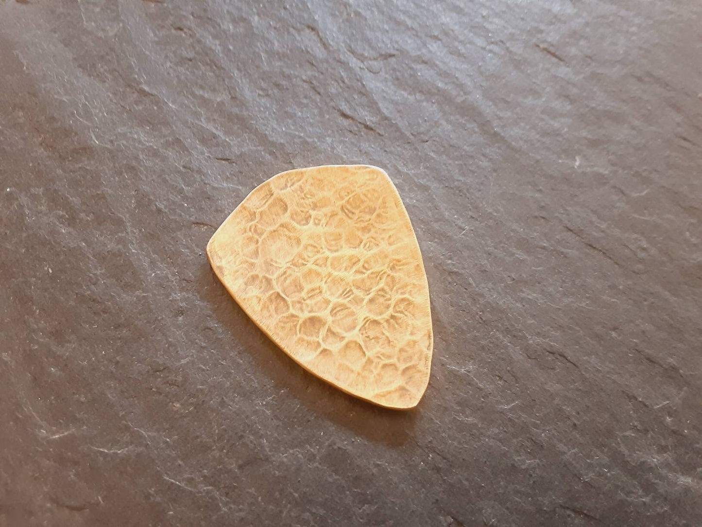 Brass shield guitar pick - playable with wild pattern - backside hammered - NicisPicks Original