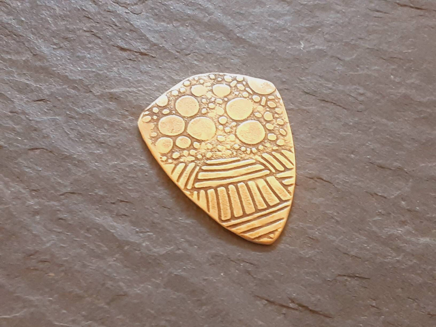 Brass shield guitar pick - playable with wild pattern - backside hammered - NicisPicks Original