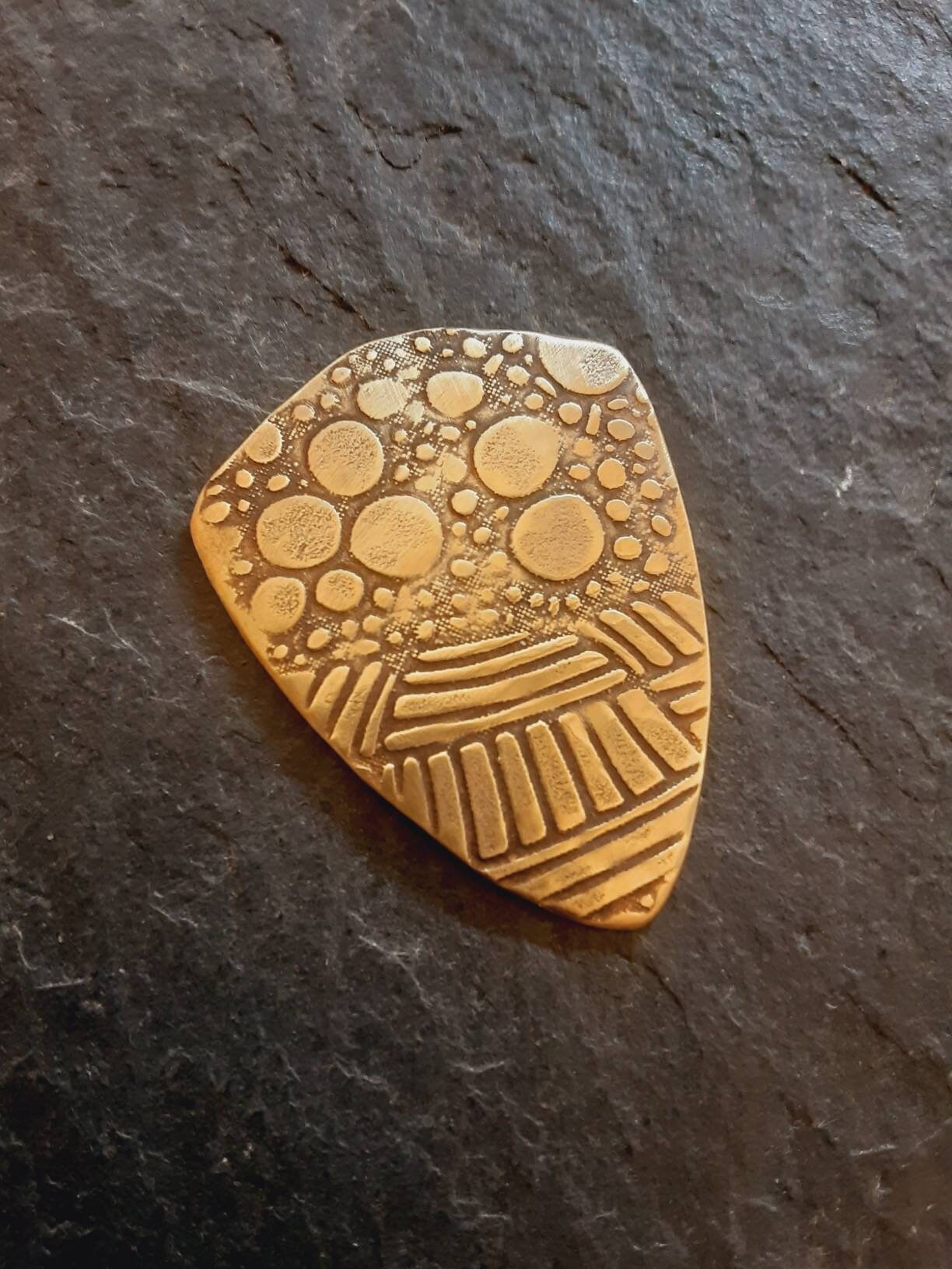 Brass shield guitar pick - playable with wild pattern - backside hammered - NicisPicks Original