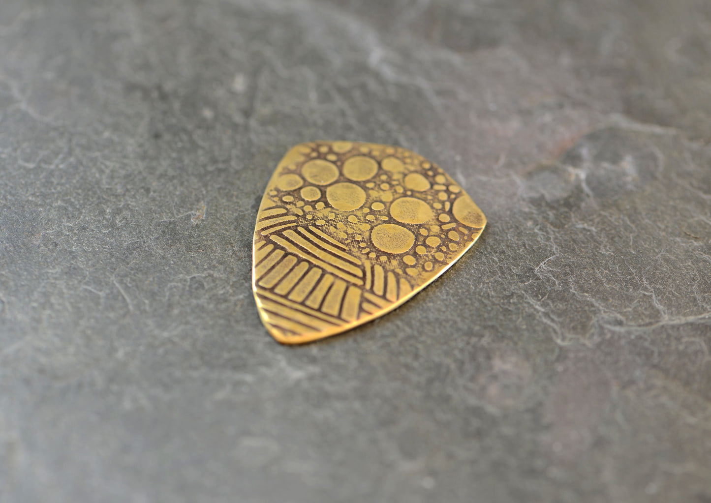 brass shield guitar pick - playable with crazy pattern
