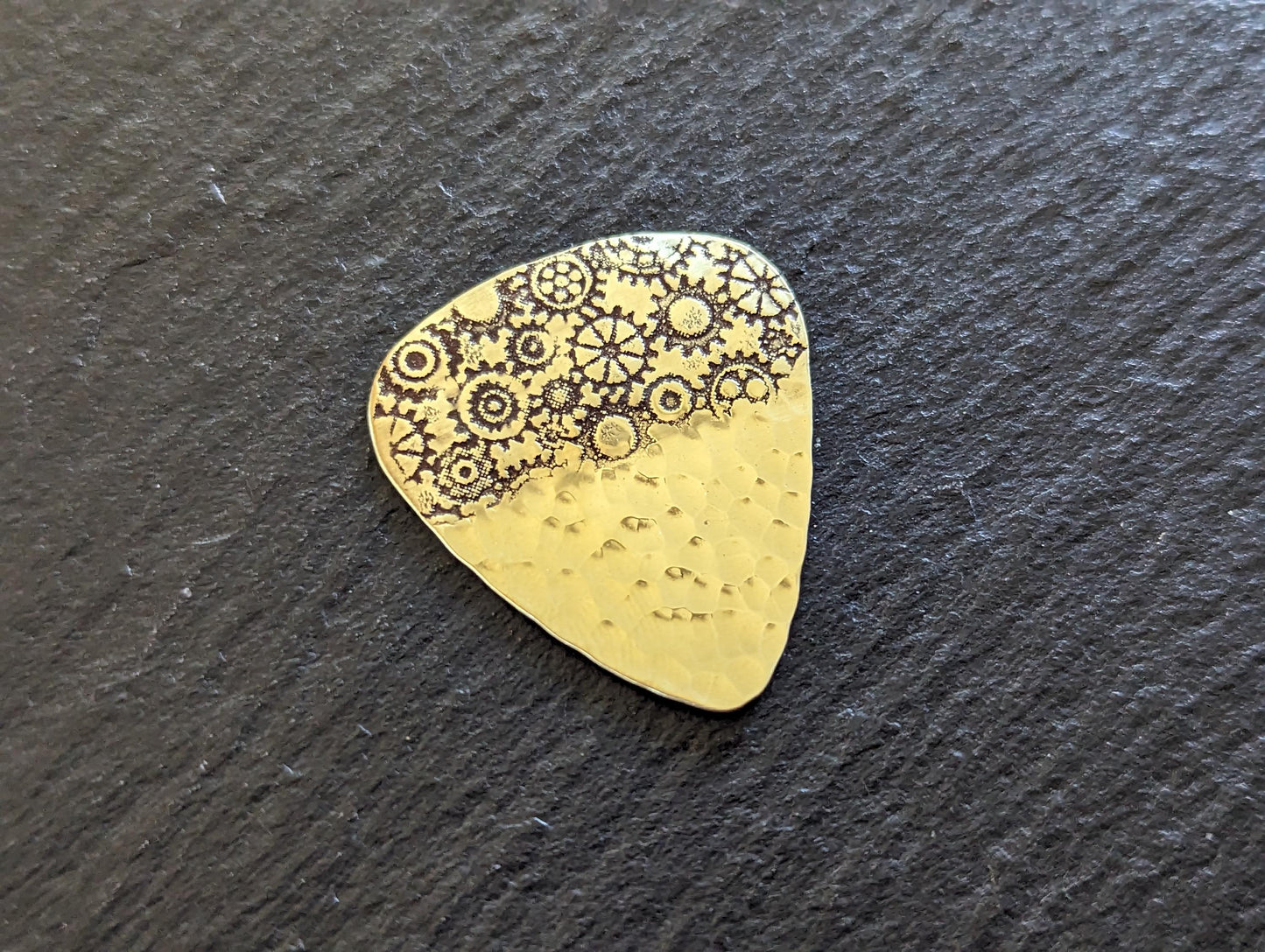 Brass guitar pick with gears and a hammered sparkling texture - playable