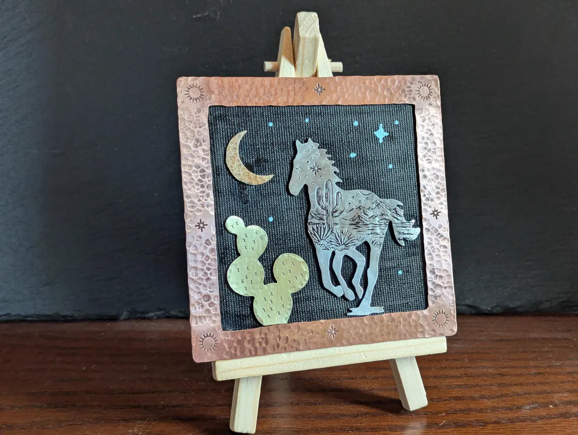 Mixed metal art piece with a running horse and a prickly pear cactus