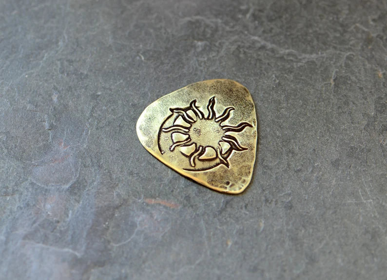 Brass guitar pick with sun and moon - handmade and playable
