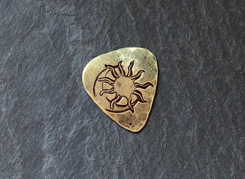 Brass guitar pick with sun and moon - handmade and playable