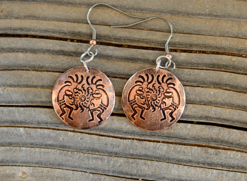 Copper dangle earrings with Kokopelli
