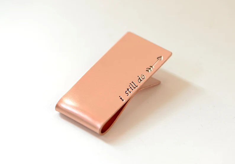 Copper money clip with I still do and an arrow