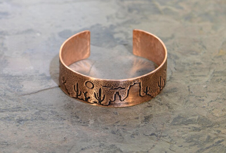 Copper cuff bracelet with a desert scene landscape and cacti