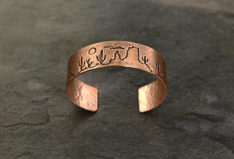 Copper cuff bracelet with a desert scene landscape and cacti