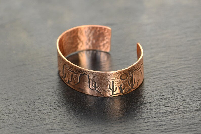 Copper cuff bracelet with a desert scene landscape and cacti