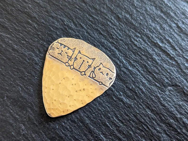 Bronze guitar pick with cats and a hammered bottom - handmade and playable