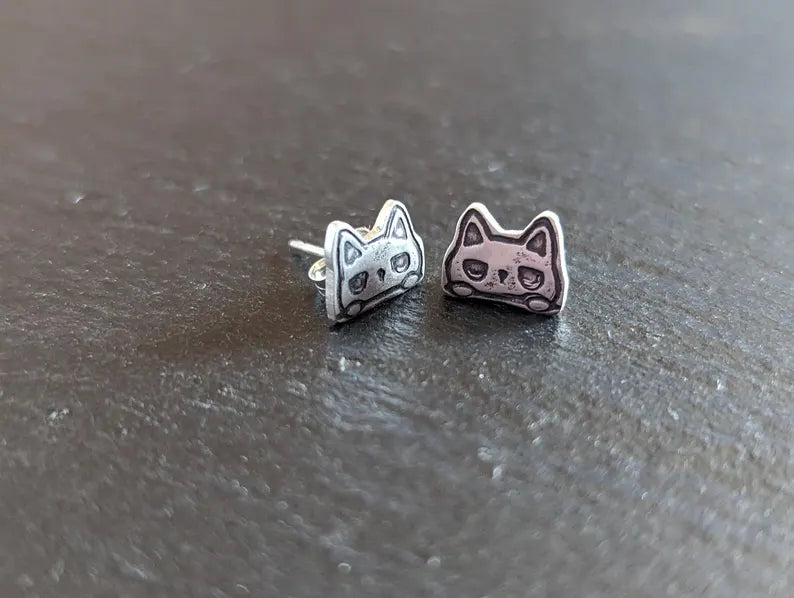 Tiny cats stud earrings made from sterling silver