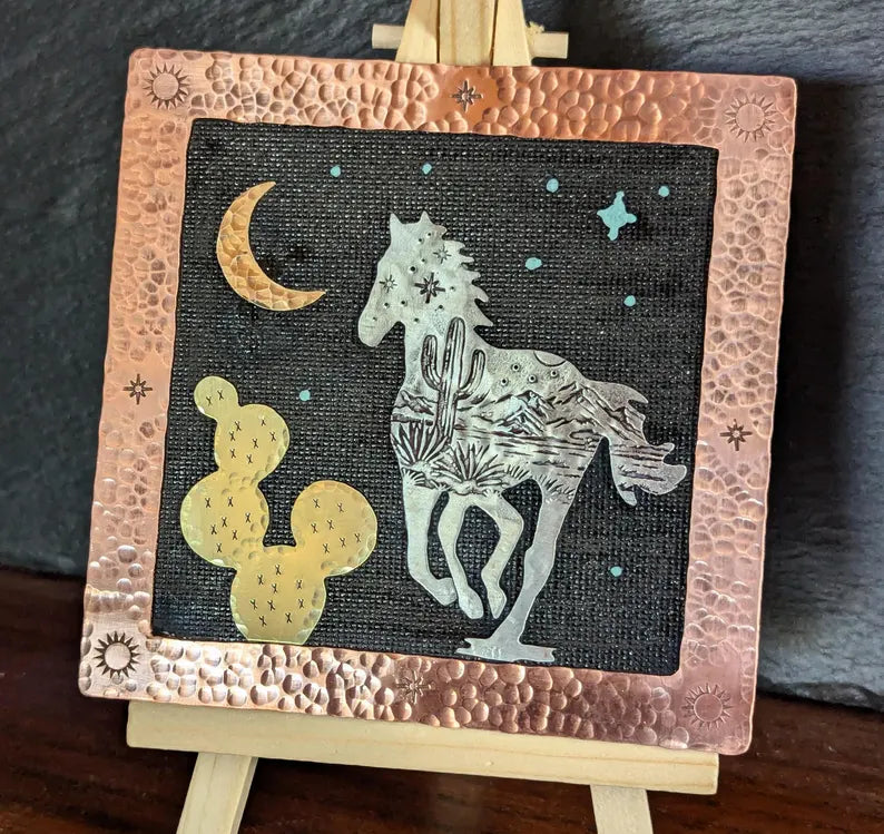 Mixed metal art piece with a running horse and a prickly pear cactus