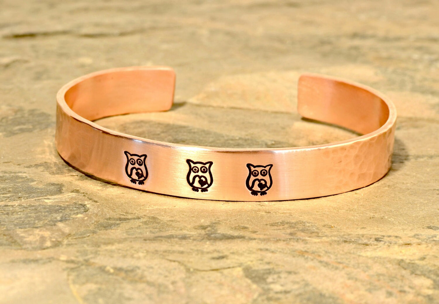 Copper cuff bracelet with hammered texture and owls