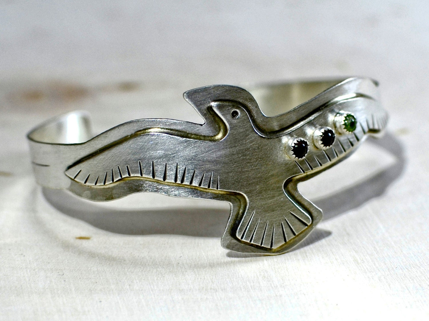 Sterling silver bird bracelet with red Garnet and green Peridots
