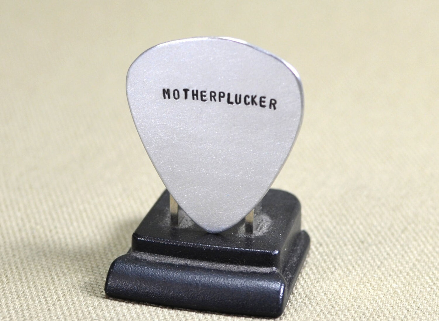 Sterling silver guitar pick with hand stamped Motherplucker