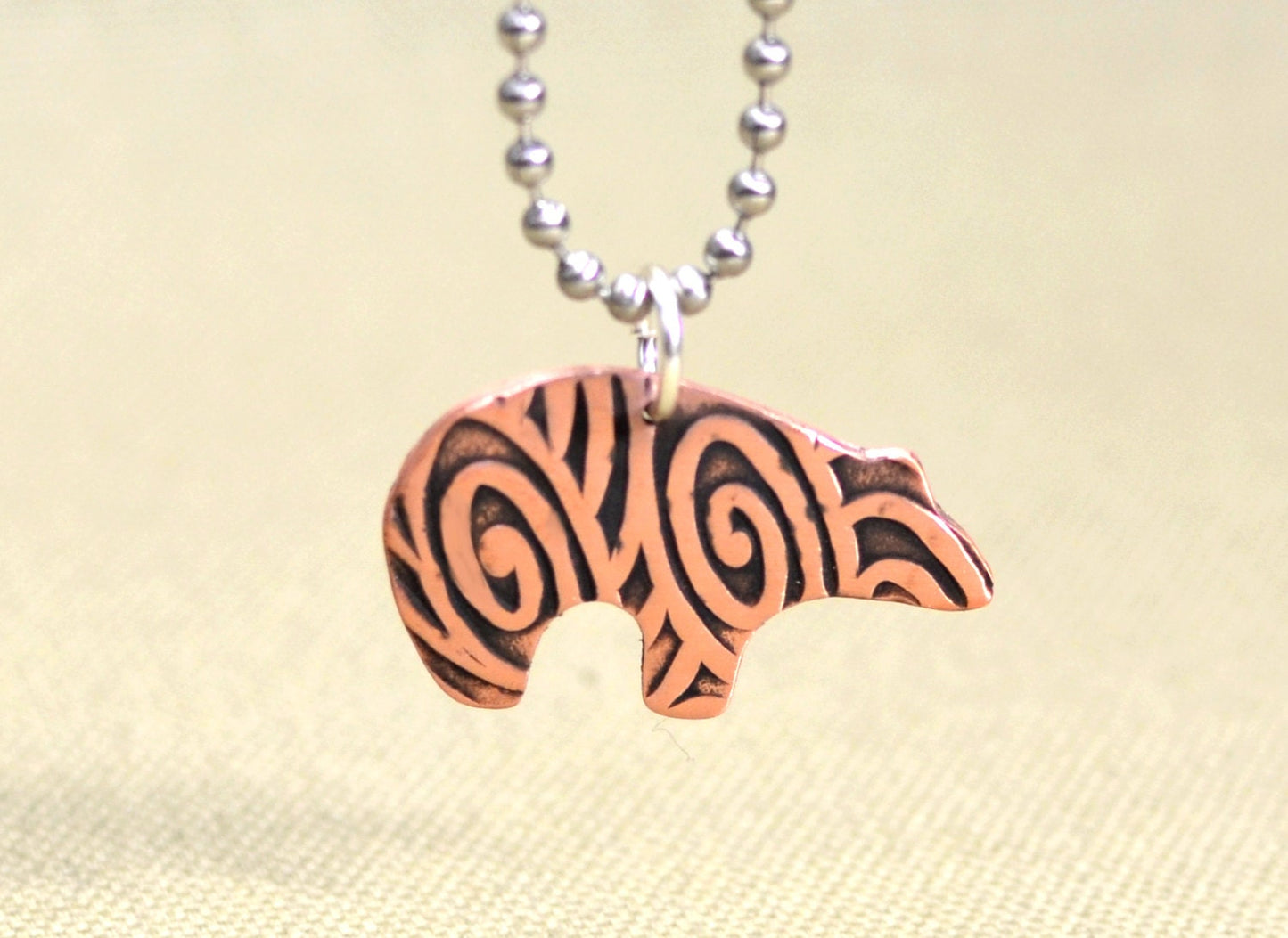 Spirit bear copper necklace with hammered and swirl texture