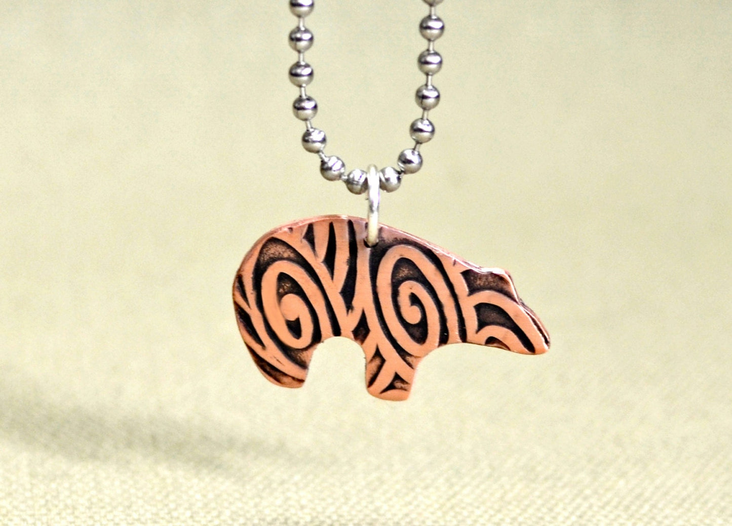 Spirit bear copper necklace with hammered and swirl texture