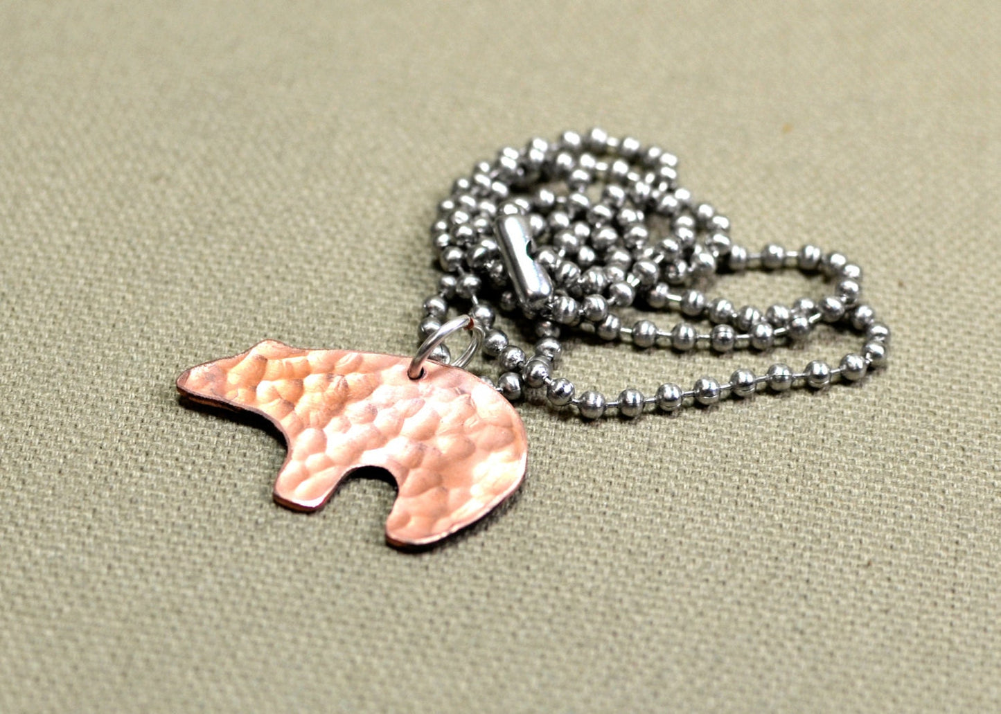 Spirit bear copper necklace with hammered and swirl texture