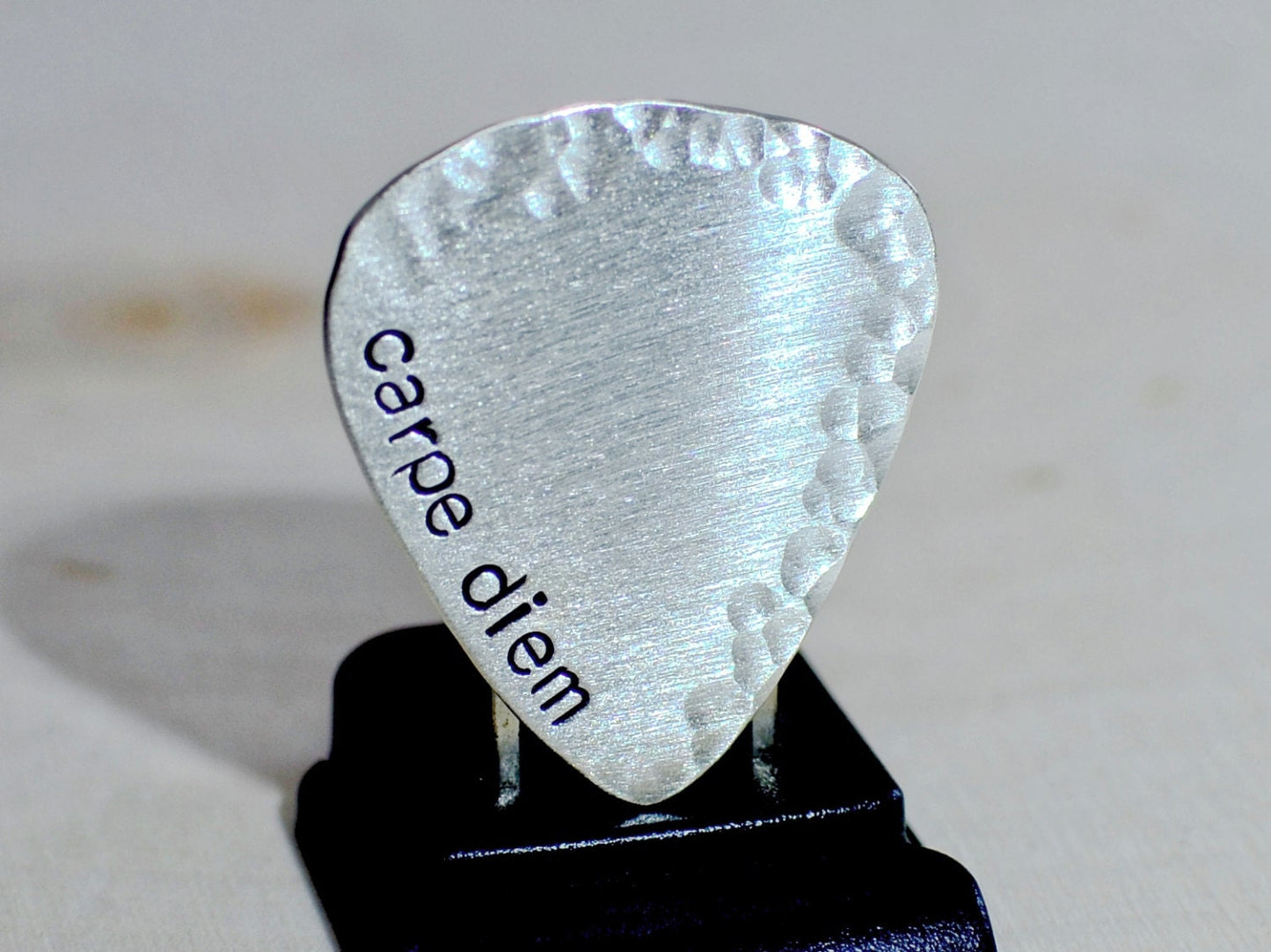 playable sterling silver guitar pick with carpe diem and a hammered border