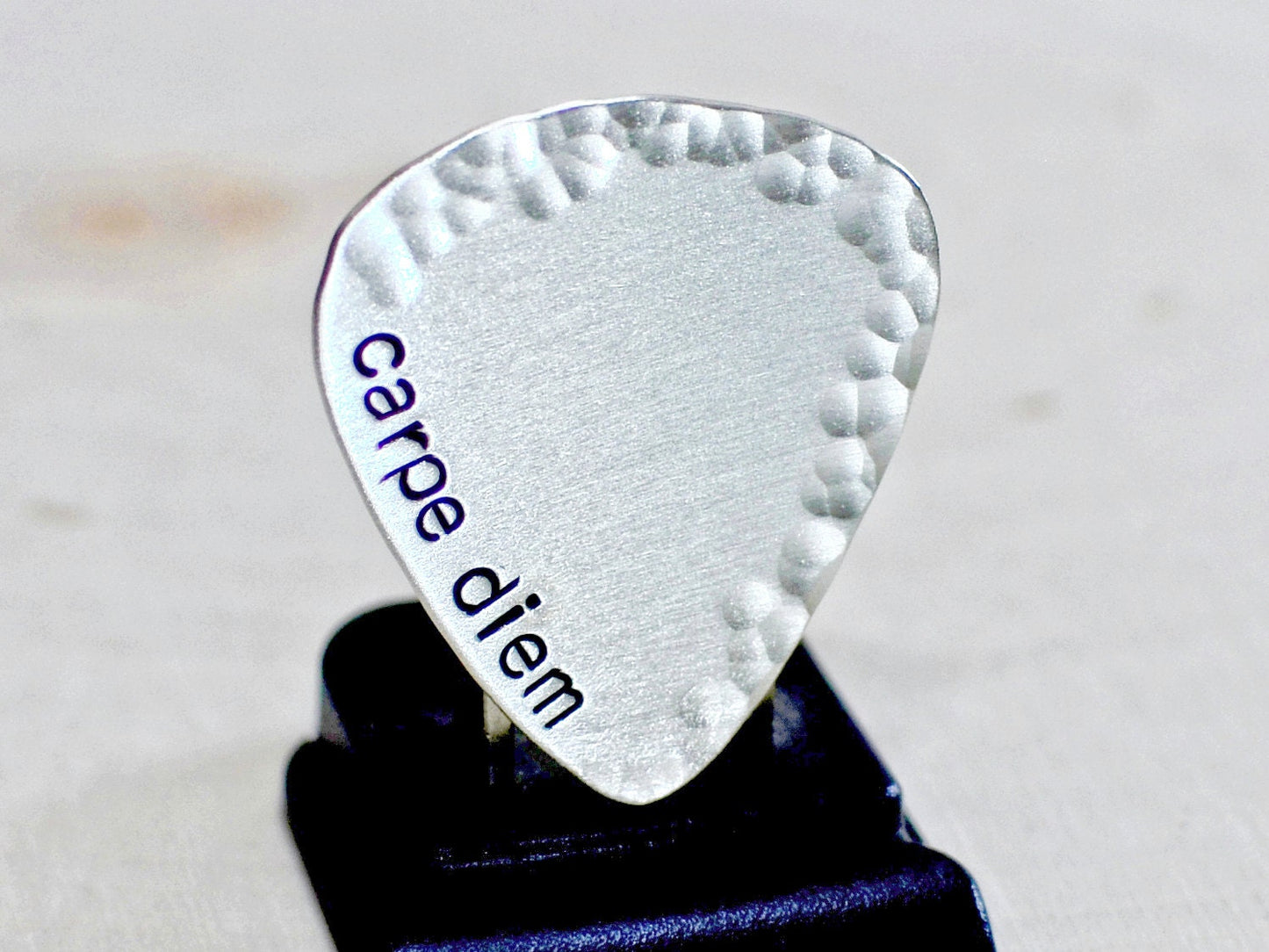 playable sterling silver guitar pick with carpe diem and a hammered border