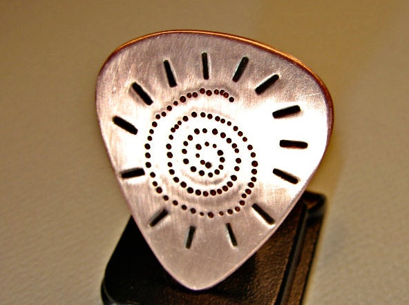 Spiral sun chased and dotted on copper guitar pick
