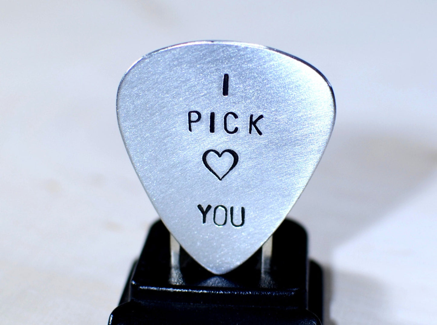 Aluminum I pick you guitar pick with a small heart design
