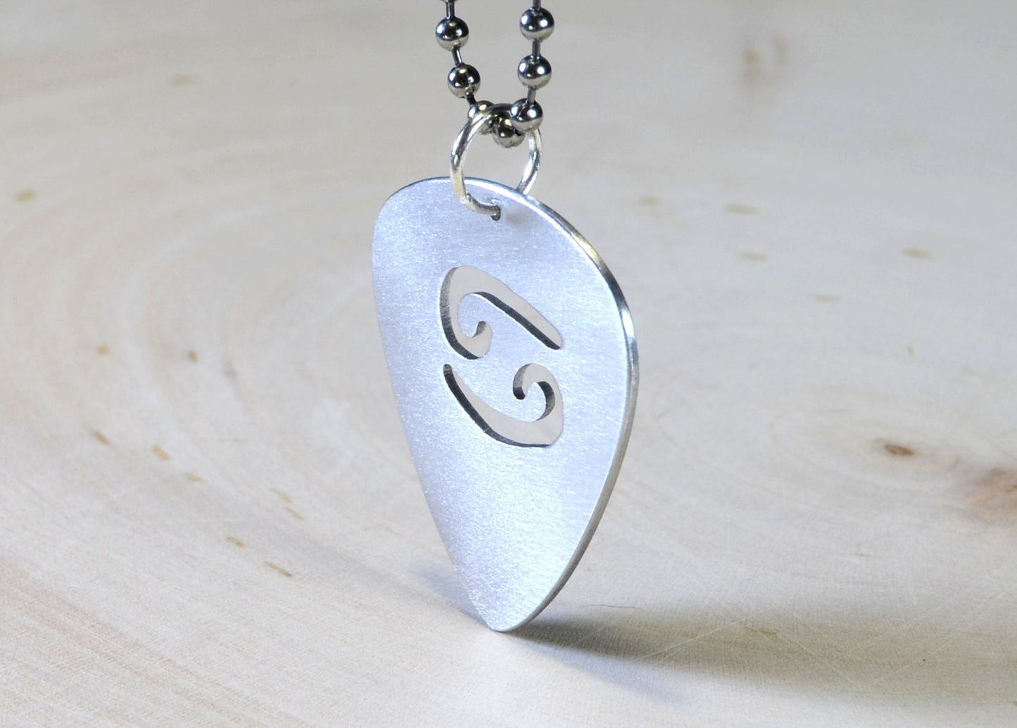 Zodiac sign guitar pick necklace with personalized astrology theme in various metals