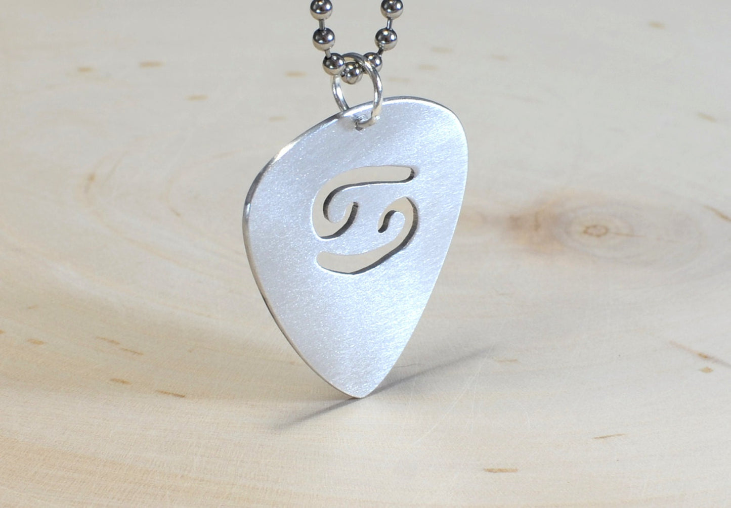 Zodiac sign guitar pick necklace with personalized astrology theme in various metals