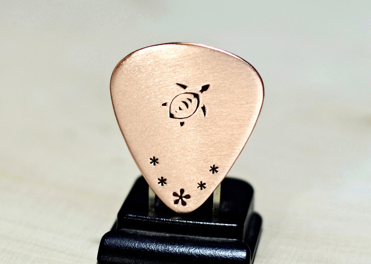 Copper guitar pick with sea turtle