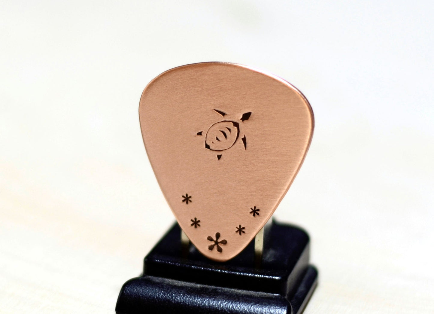 Copper guitar pick with sea turtle