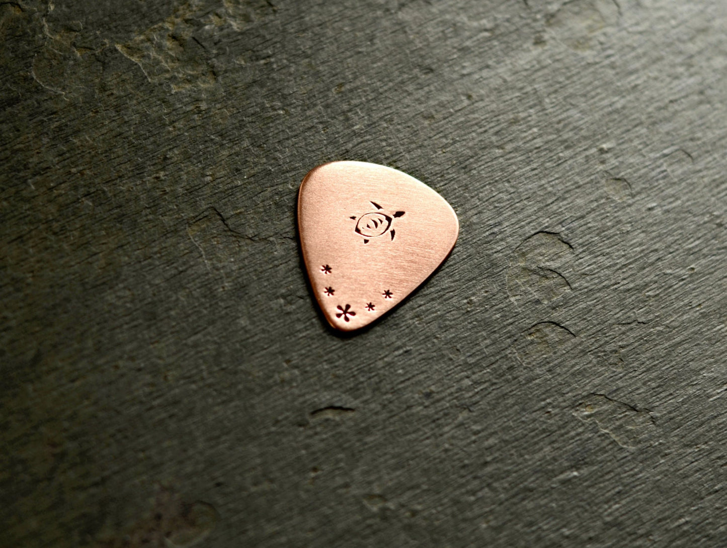 Copper guitar pick with sea turtle