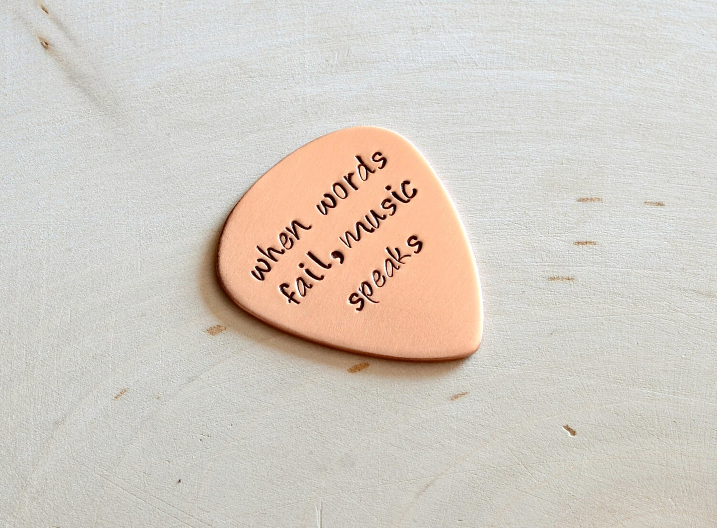 Guitar Pick with When Words Fail Music Speaks in Copper