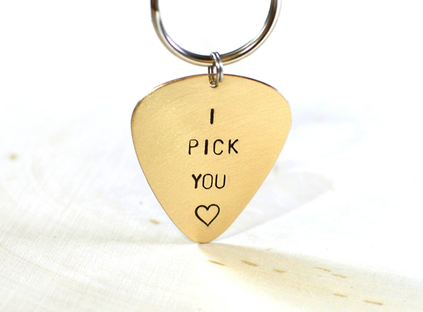 Bronze guitar pick keychain stamped with I PICK YOU