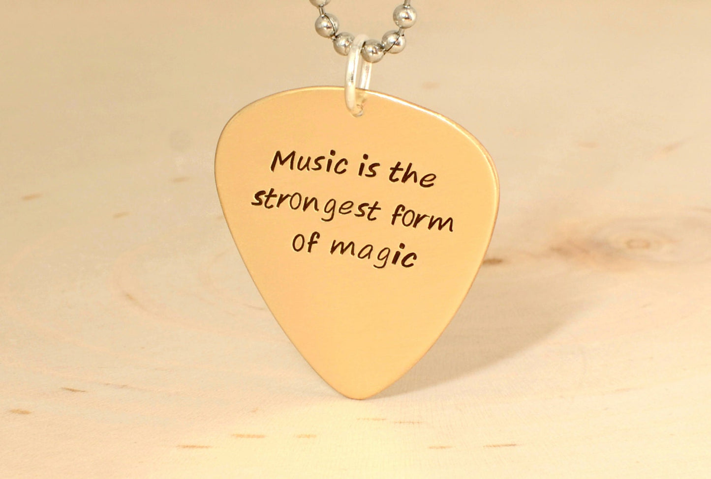 Bronze guitar pick necklace to engrave