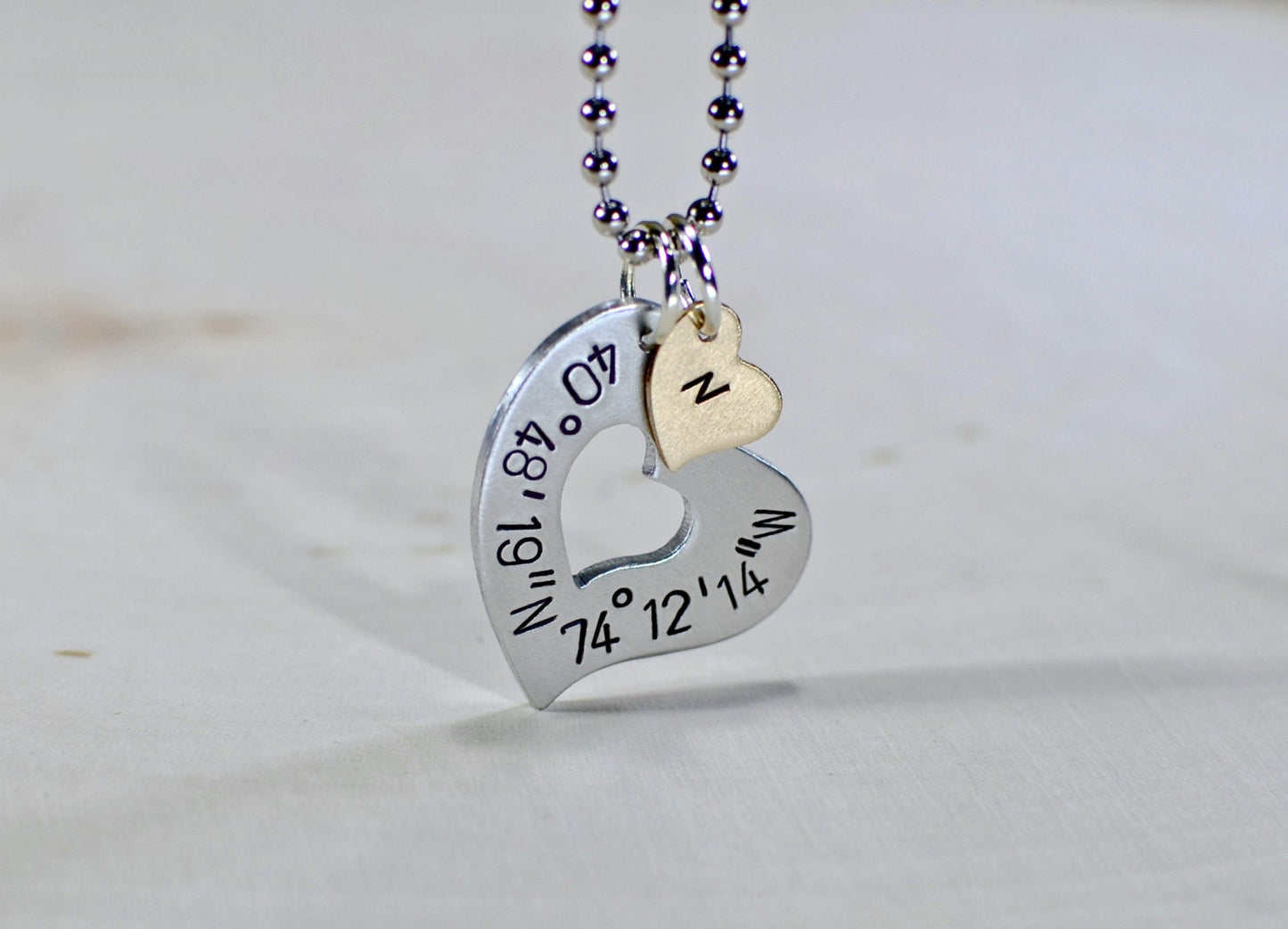 Sterling silver heart necklace with personalized latitude longitude coordinates with Bronze Heart Charm