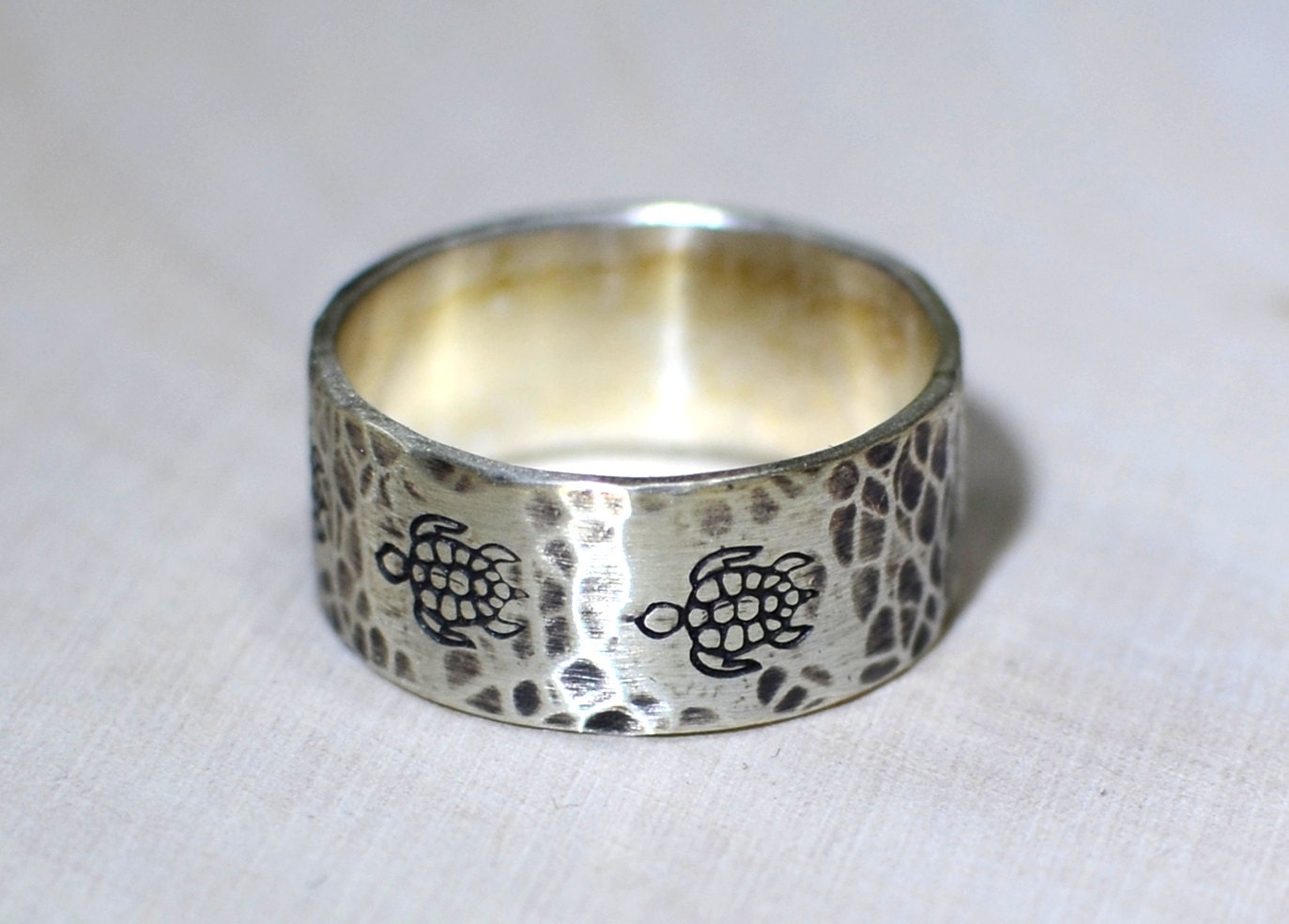Sterling silver ring with rustic sea turtles and hammered patterning