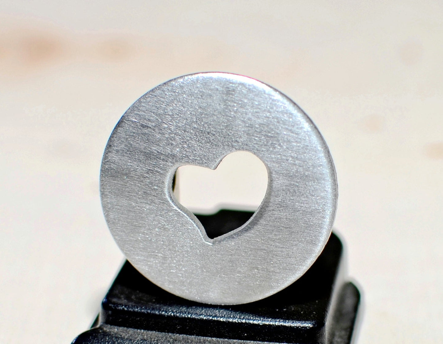 Golf ball marker with a heart cut out